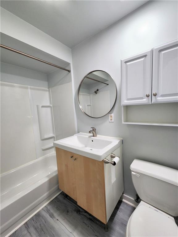 5237 Butler Street, Unit 3 Pittsburgh, PA 15201 - Photo 4 of 6 a bathroom with a toilet a sink and mirror