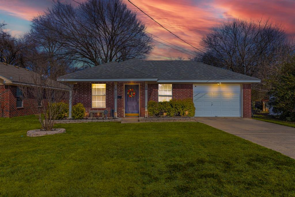 1202 Spring Street Waco, TX 76704 - Photo 2 of 16 a front view of a house with a garden and porch
