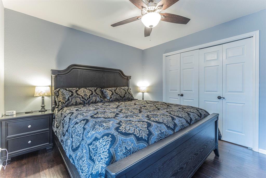 1202 Spring Street Waco, TX 76704 - Photo 8 of 16 a bedroom with a bed and a chandelier