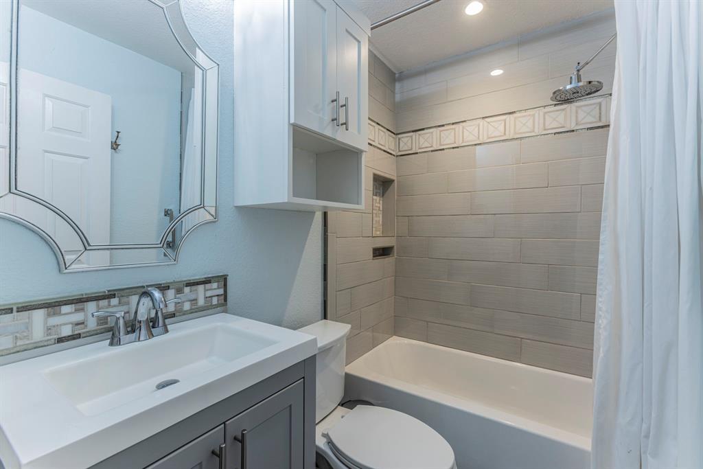 1202 Spring Street Waco, TX 76704 - Photo 9 of 16 a bathroom with a sink toilet and shower