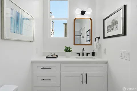 a bathroom with a sink vanity and mirror