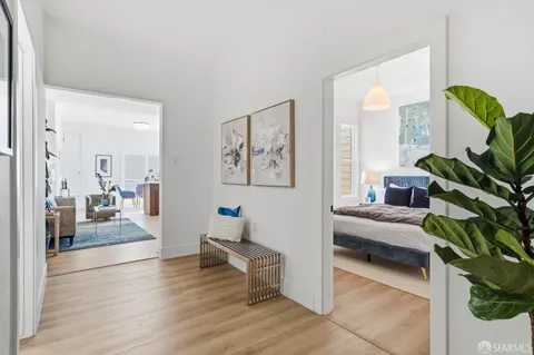 a bedroom with a bed and a painting on the wall