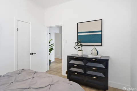 a bedroom with a bed and a mirror