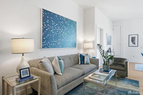 a living room with furniture a lamp and a potted plant