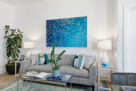 a living room with furniture a dining table and kitchen view