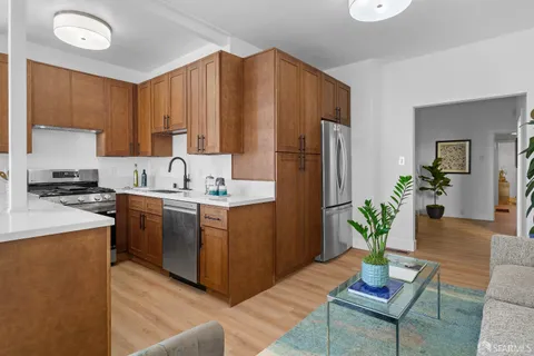 a kitchen with a sink stove and cabinets