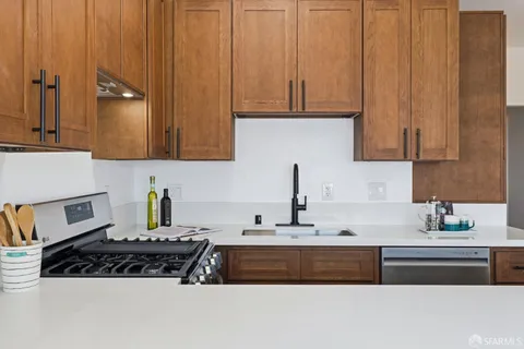 a stove top oven sitting inside of a kitchen