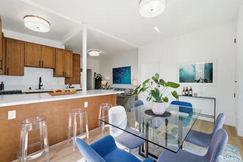 a dining room with furniture and window