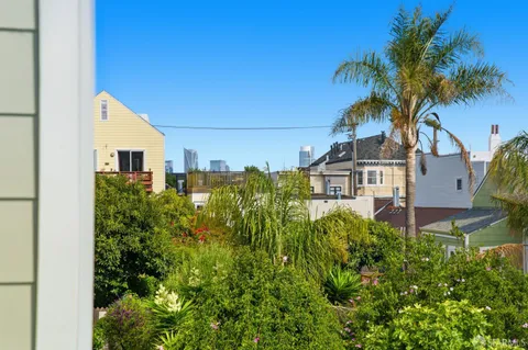 a view of a patio with a table and chairs and potted plants