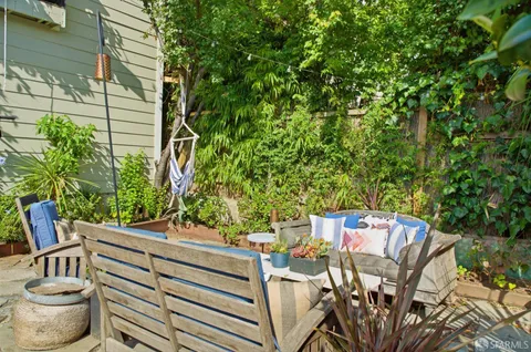 a view of an outdoor sitting area with furniture and garden view