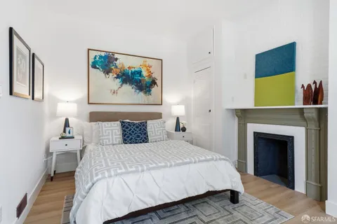 a bedroom with a bed and a painting on the wall