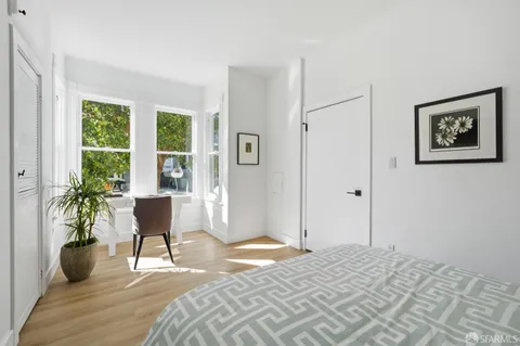 a bedroom with a bed and a potted plant