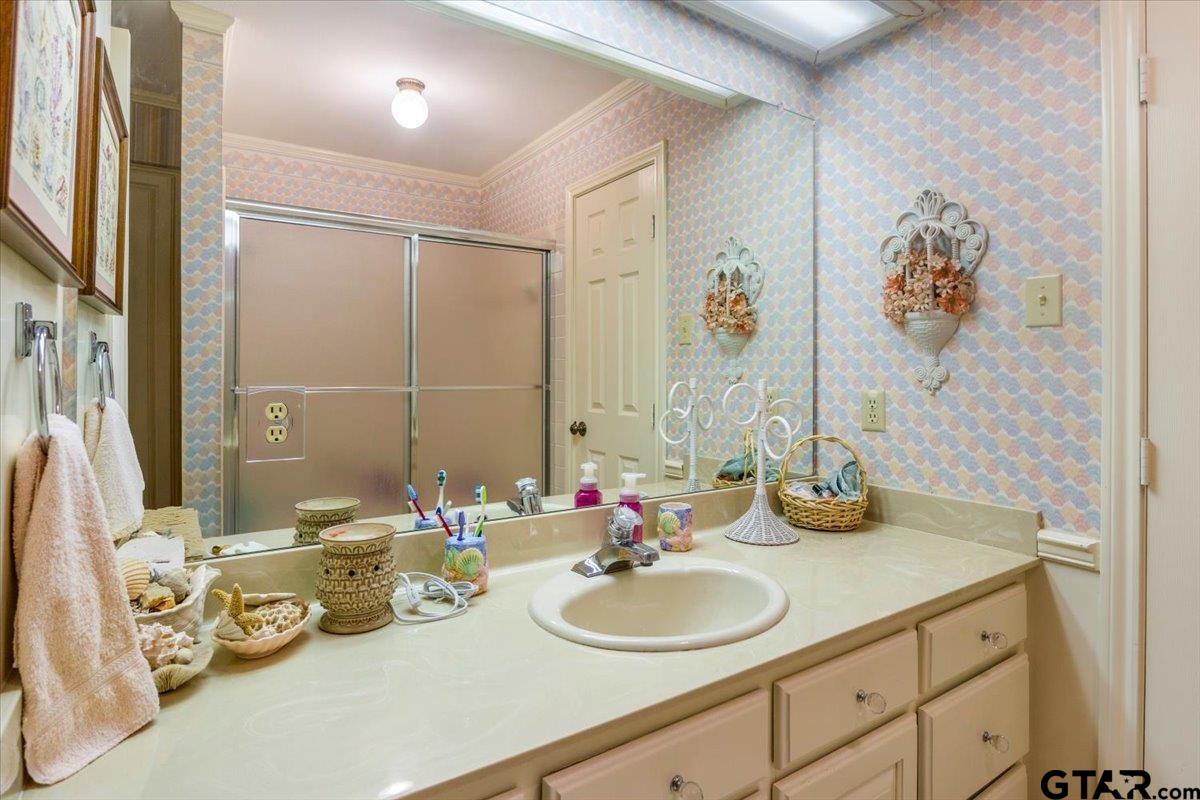 15246 7 League Road Tyler, TX 75703 - Photo 16 of 43 a bathroom with double vanity sinks and a mirror
