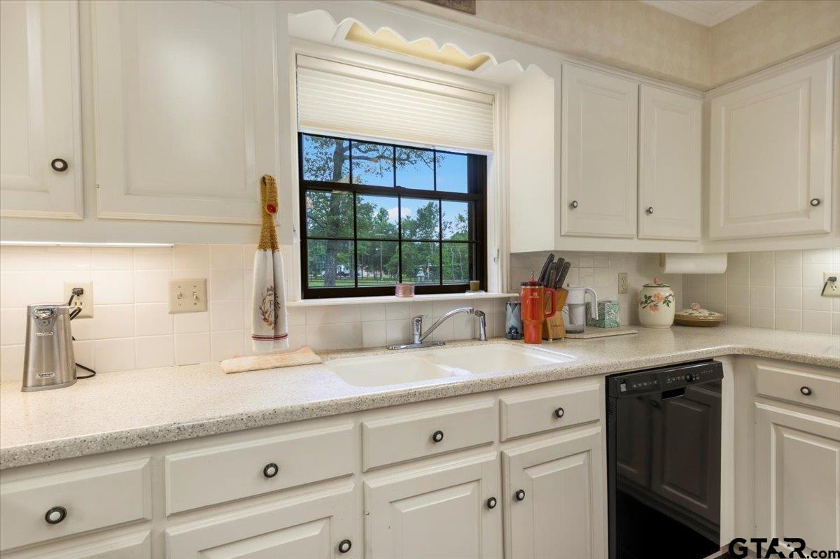 15246 7 League Road Tyler, TX 75703 - Photo 21 of 43 a kitchen with granite countertop white cabinets and white appliances