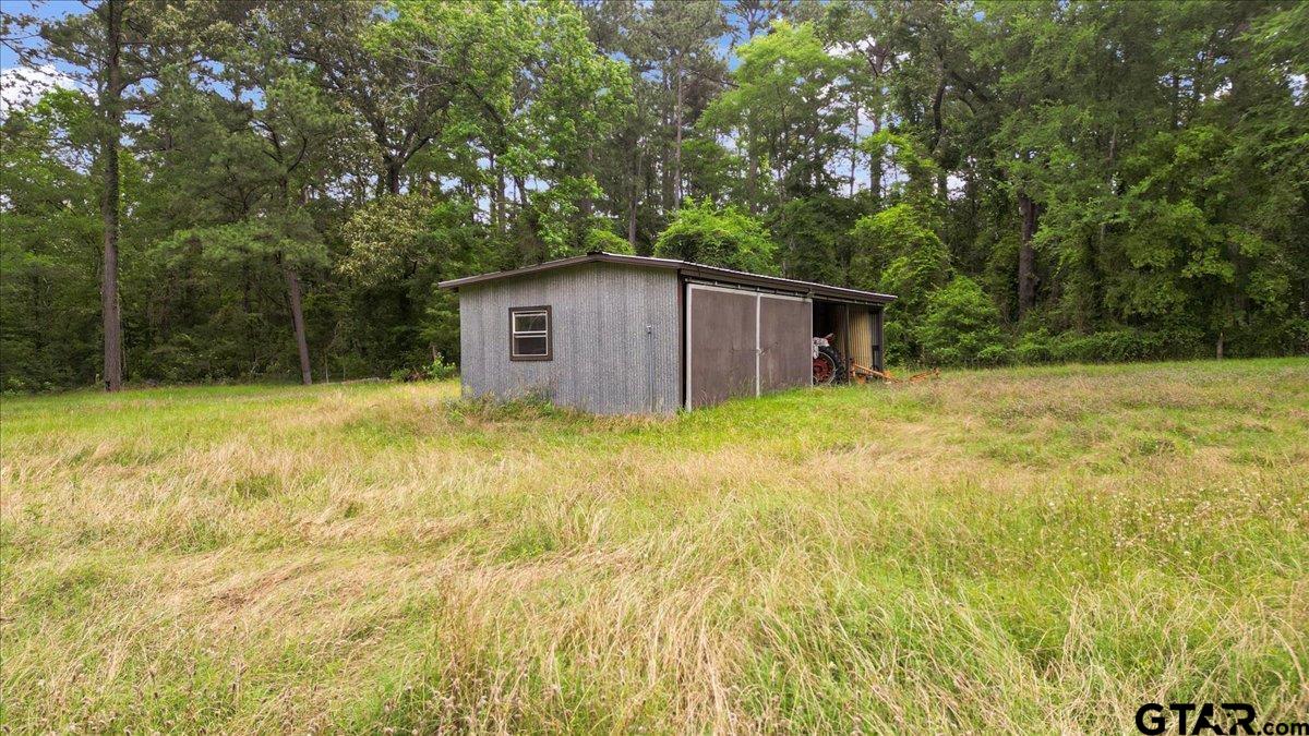 15246 7 League Road Tyler, TX 75703 - Photo 40 of 43 a backyard of a house with large trees