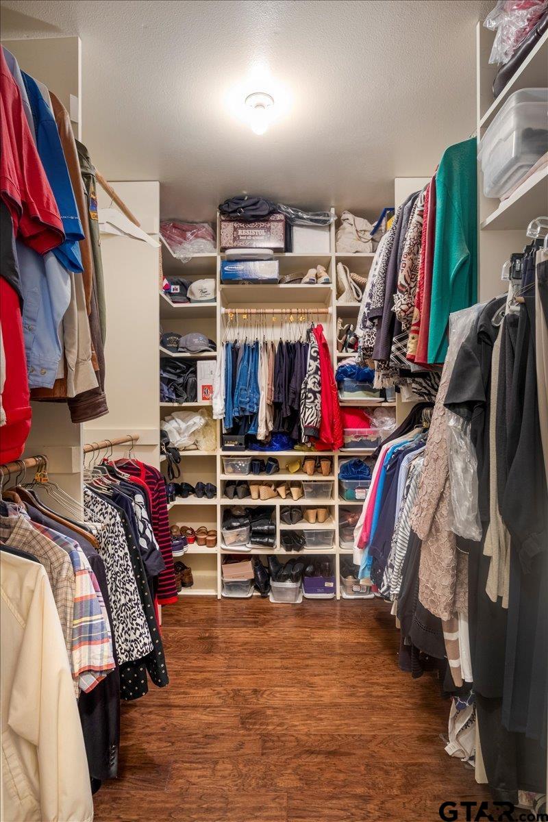 15246 7 League Road Tyler, TX 75703 - Photo 9 of 43 a view of walk in closet with clothes and shoes