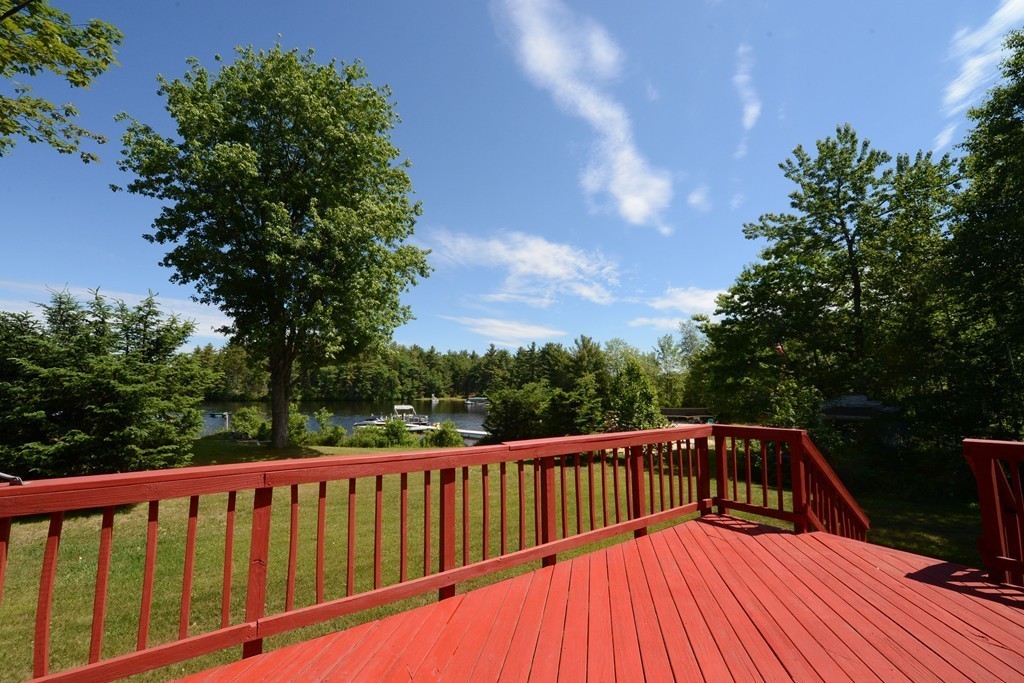 a view of balcony with wooden floor and fence