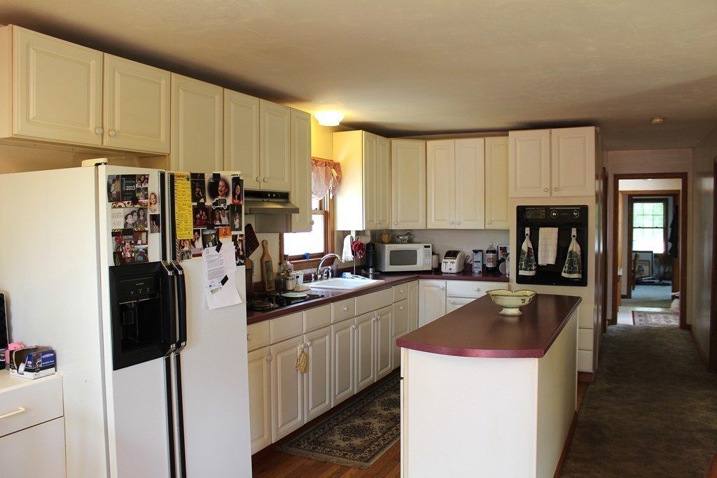 124 Sherbert Road Ashburnham, MA 01430 - Photo 8 of 27 a kitchen with a sink a refrigerator and cabinets