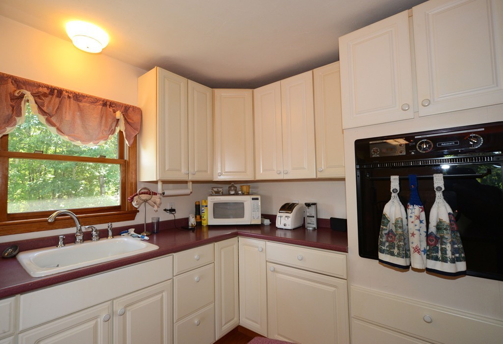 124 Sherbert Road Ashburnham, MA 01430 - Photo 10 of 27 a kitchen with a sink and cabinets