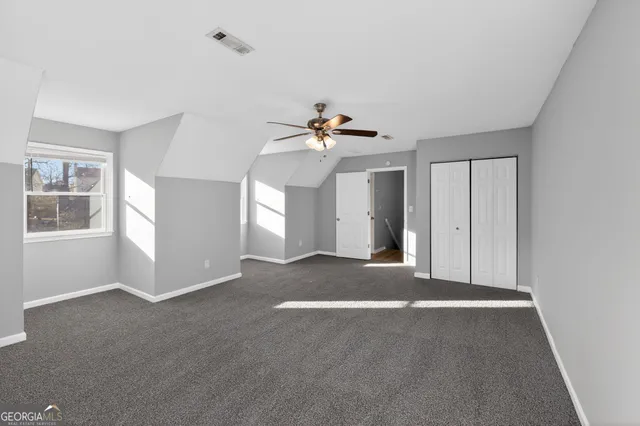 a view of a livingroom with a ceiling fan and window
