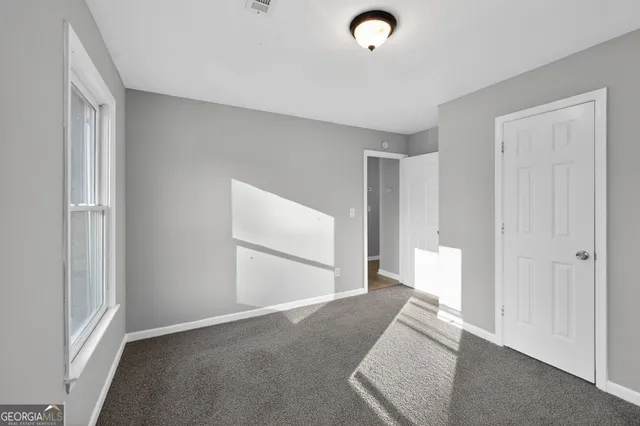 a view of a room with wooden floor and window