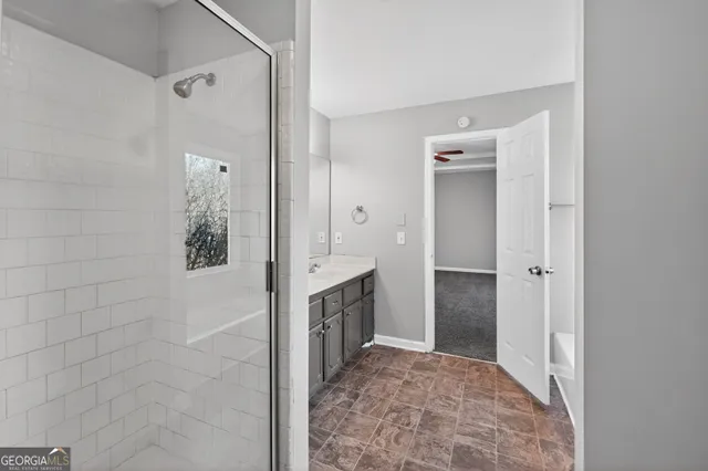 a bathroom with a tub and shower