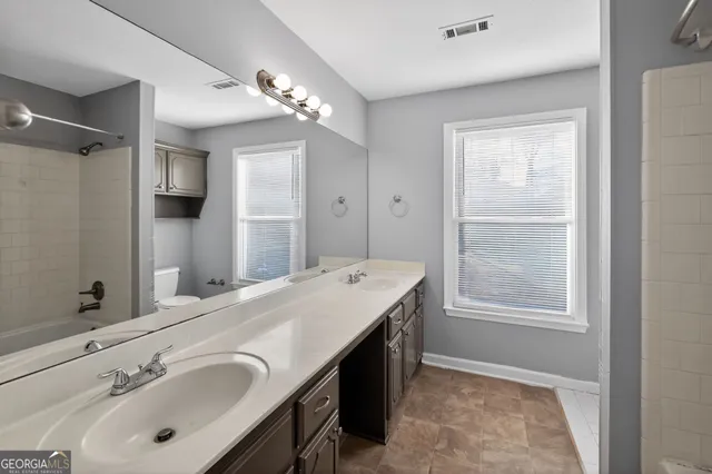 a en suite bathroom with a double vanity sink mirror and double