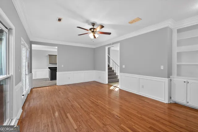 wooden floor in an empty room with a window