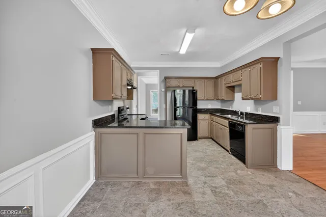 a kitchen with granite countertop a sink stainless steel appliances and cabinets