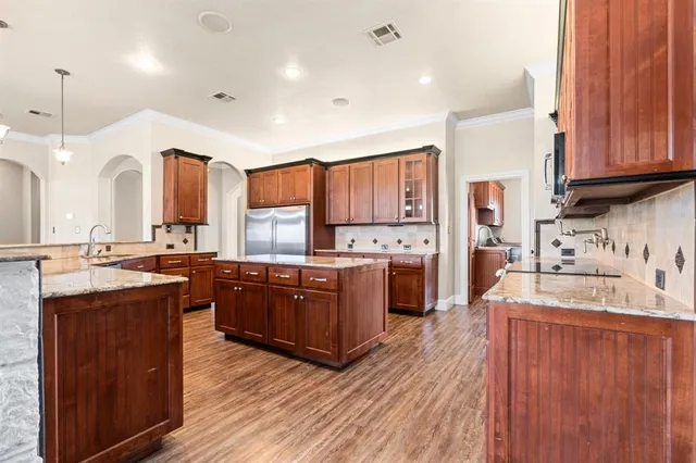 a view of empty room with wooden floor and fireplace