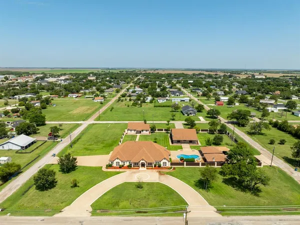 an aerial view of a house with a yard