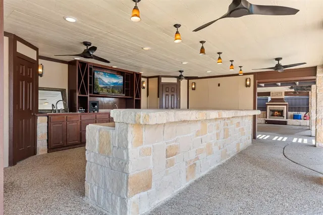 a large living room with stainless steel appliances kitchen island granite countertop a couch and a stove