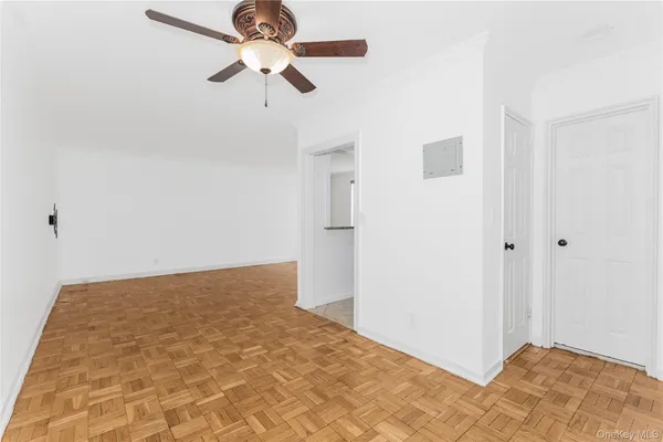 a view of empty room with wooden floor