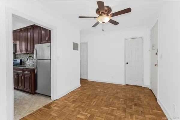 a view of a kitchen with a refrigerator and a ceiling fan