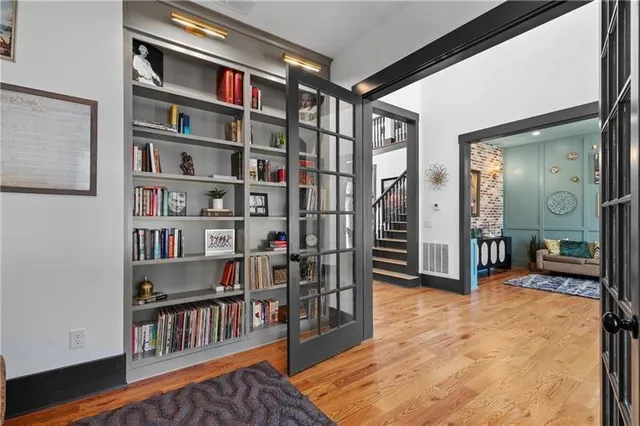 a kitchen with a sink stove and wooden floor