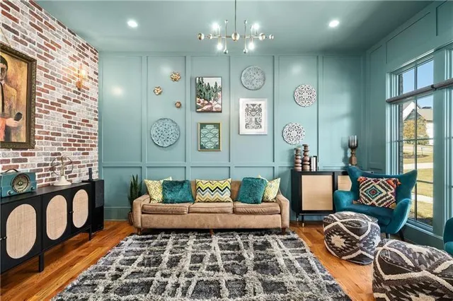 a dining room with furniture a chandelier and wooden floor