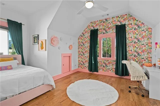 a kitchen with stainless steel appliances a stove a refrigerator a sink and a dining table with chairs