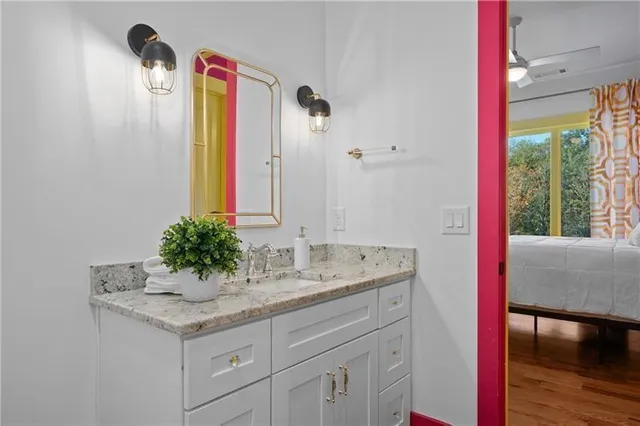 a living room with furniture and a ceiling fan