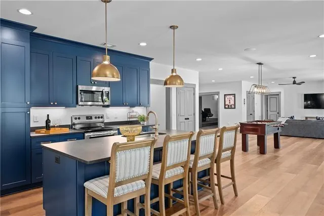 a en suite bathroom with a granite countertop sink and a mirror
