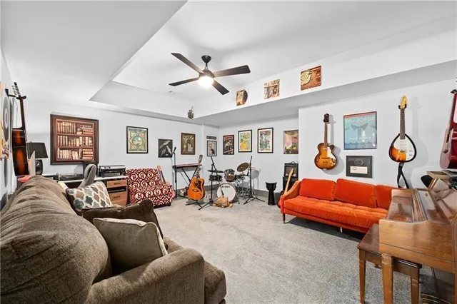 a bathroom with a granite countertop toilet a sink and a mirror