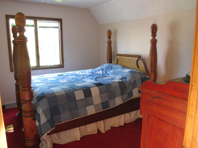 83 North 43rd Road Mendota, IL 61342 - Photo 16 of 25 a bedroom with a bed and a mirror
