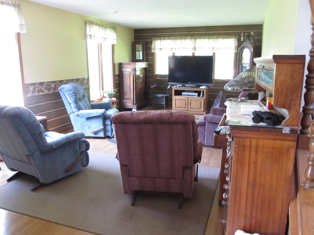 83 North 43rd Road Mendota, IL 61342 - Photo 3 of 25 a living room with furniture and a flat screen tv