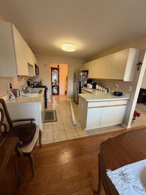 74 Riverview Court Secaucus, NJ 07094 - Photo 4 of 7 a kitchen with sink a stove and chairs