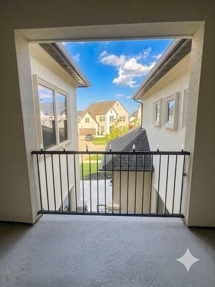 6825 Entwistle Road Frisco, TX 75034 - Photo 11 of 25 This property features a balcony with a black metal railing, offering views of surrounding homes and a clear blue sky with clouds