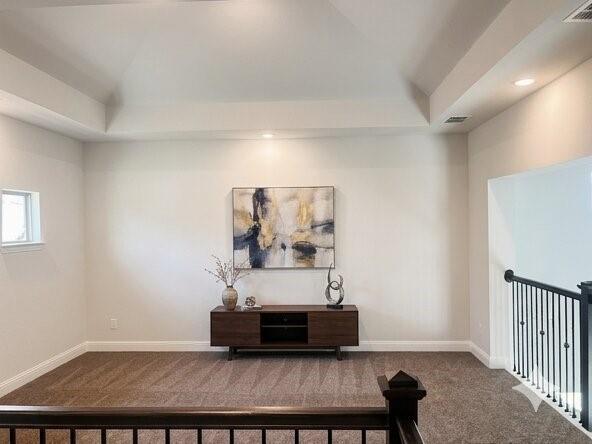 6825 Entwistle Road Frisco, TX 75034 - Photo 13 of 25 This inviting space features a tray ceiling with recessed lighting, carpeted flooring, and a window providing natural light