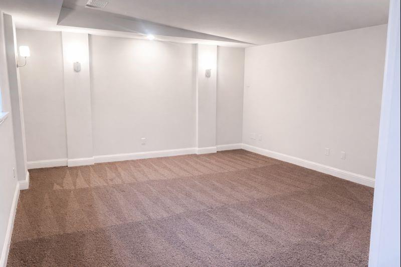 6825 Entwistle Road Frisco, TX 75034 - Photo 16 of 25 Spacious room featuring neutral carpeting, white walls, recessed lighting, and wall sconces