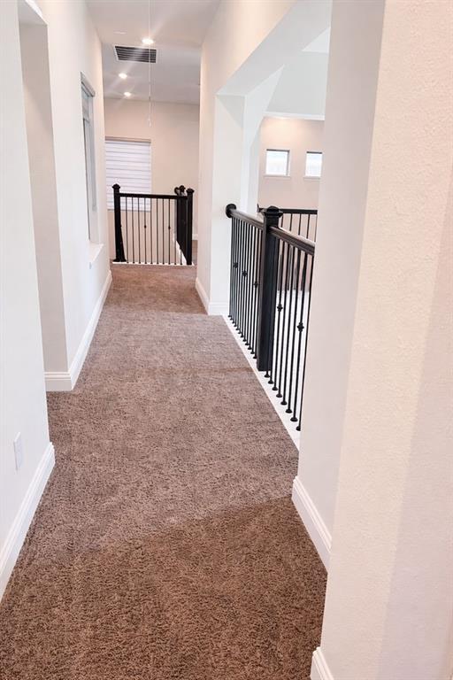 6825 Entwistle Road Frisco, TX 75034 - Photo 17 of 25 Carpeted hallway with white walls and baseboards