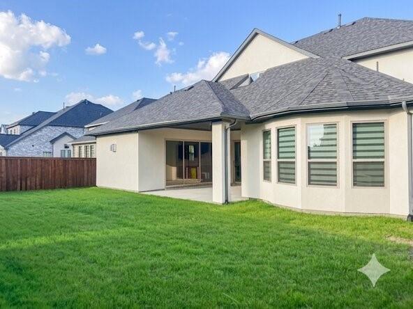 6825 Entwistle Road Frisco, TX 75034 - Photo 25 of 25 The property features a spacious backyard with a well-maintained lawn and a private wooden fence