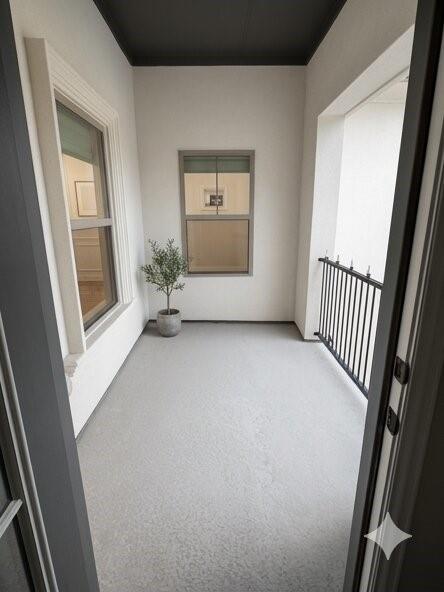 6825 Entwistle Road Frisco, TX 75034 - Photo 10 of 25 An inviting outdoor space featuring a smooth floor, white walls, and a dark ceiling