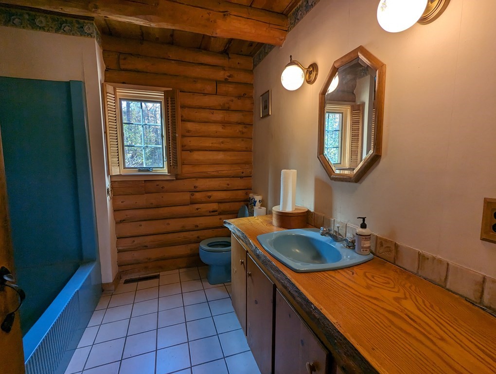 1183 Townsend Road Mason, NH 03048 - Photo 16 of 32 a bathroom with a sink and a mirror